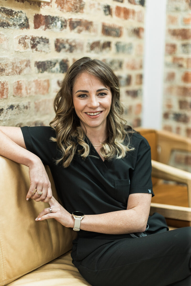 Dr Leande Kotze, specialist periodontist, seated at the practice.